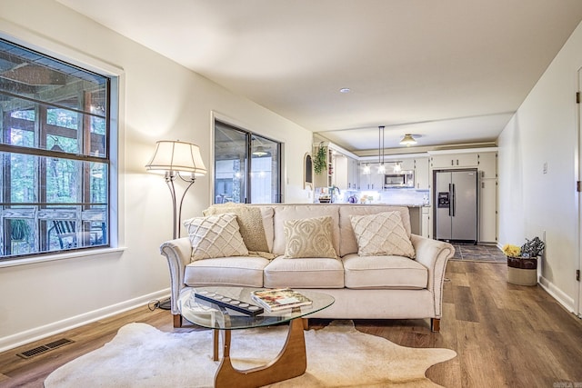 30 Segovia Dr, Hot Springs Village, AR 71909 - living room with baseboards and dark wood-style flooring