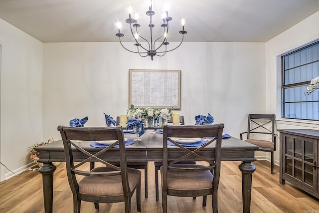 30 Segovia Dr, Hot Springs Village, AR 71909 - dining room featuring a chandelier, light wood-type flooring, and baseboards
