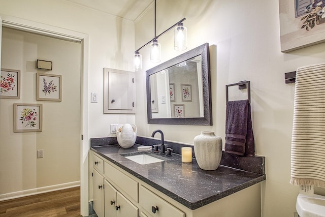 30 Segovia Dr, Hot Springs Village, AR 71909 - bathroom featuring vanity, wood finished floors, ornamental molding, and baseboards
