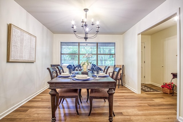 30 Segovia Dr, Hot Springs Village, AR 71909 - dining area with a chandelier, light wood finished floors, and baseboards