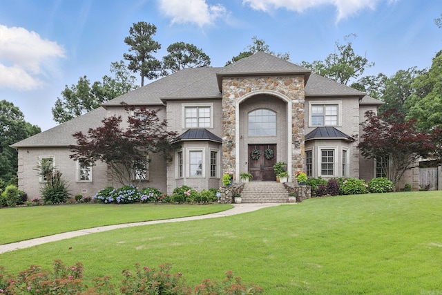 53 Maisons, Little Rock, AR 72223 - french country inspired facade with a standing seam roof, a front yard, and french doors