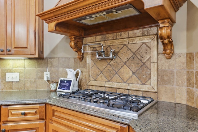 53 Maisons, Little Rock, AR 72223 - kitchen with premium range hood, stainless steel gas stovetop, and decorative backsplash