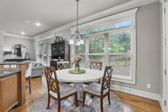 53 Maisons, Little Rock, AR 72223 - dining area with crown molding, baseboards, light wood-style floors, and a chandelier
