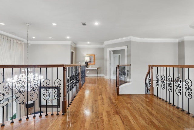53 Maisons, Little Rock, AR 72223 - hall with crown molding, wood finished floors, an upstairs landing, recessed lighting, and a chandelier