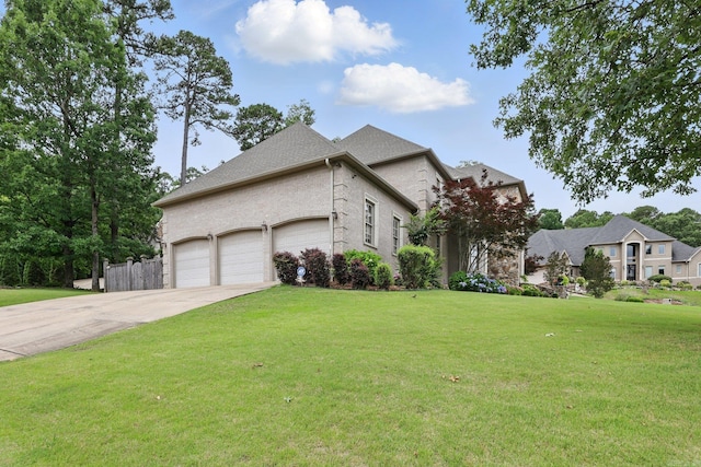 53 Maisons, Little Rock, AR 72223 - view of front of house featuring concrete driveway, an attached garage, and a front yard