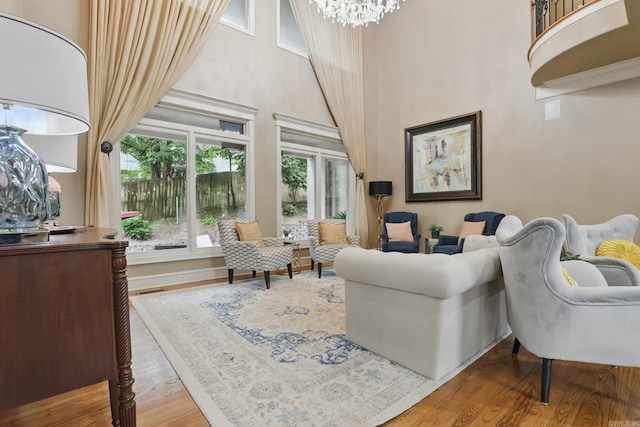 53 Maisons, Little Rock, AR 72223 - living room featuring a chandelier, a towering ceiling, and wood finished floors