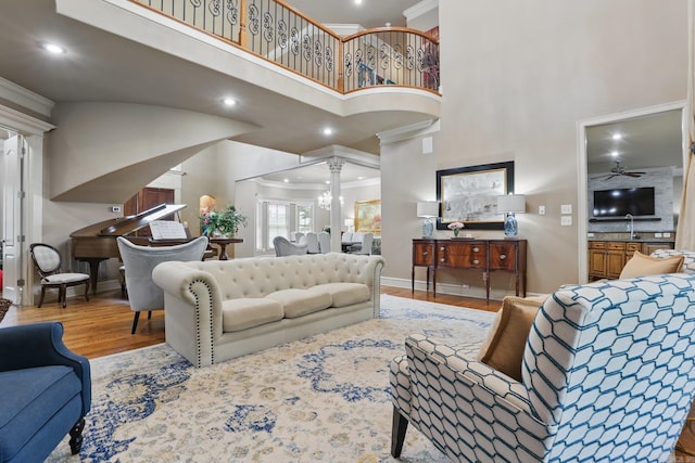 53 Maisons, Little Rock, AR 72223 - living area with wood finished floors, ornate columns, a high ceiling, baseboards, and crown molding