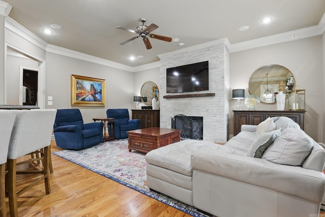 53 Maisons, Little Rock, AR 72223 - living room featuring ceiling fan, light wood-type flooring, ornamental molding, a brick fireplace, and recessed lighting