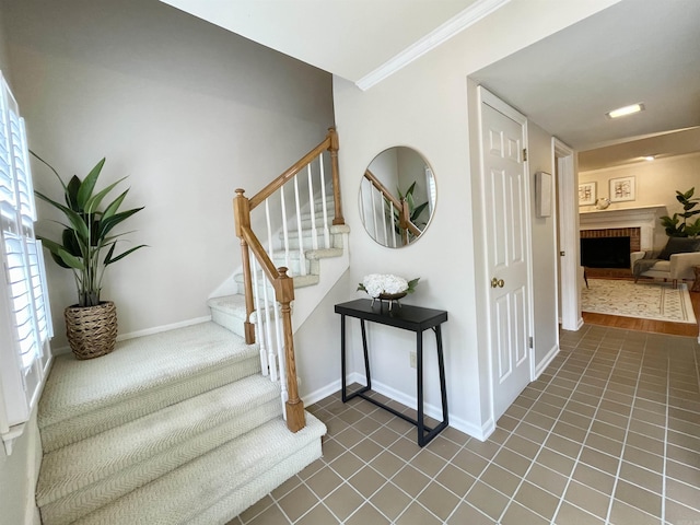 2200 Andover Ct Unit 403, Little Rock, AR 72227 - stairway with a brick fireplace, tile patterned flooring, ornamental molding, and baseboards