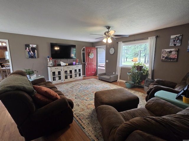 2373 W Rd, Mount Pleasant, AR 72561 - living room featuring a ceiling fan, wood finished floors, a textured ceiling, and baseboards
