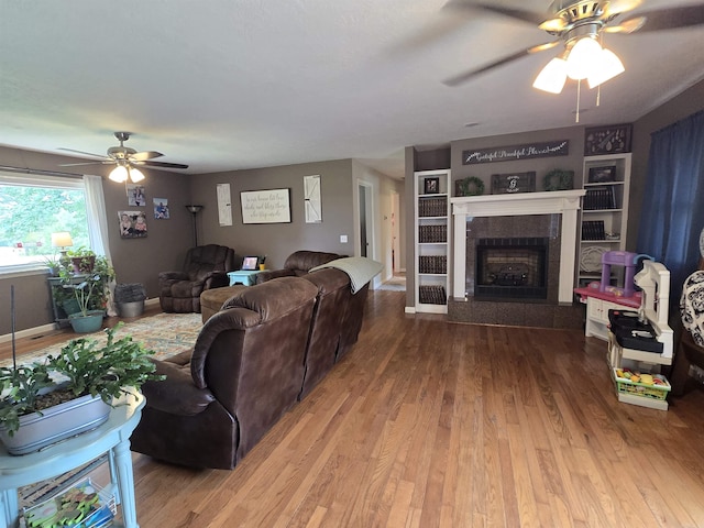 2373 W Rd, Mount Pleasant, AR 72561 - living room featuring ceiling fan, wood finished floors, a fireplace, and built in shelves