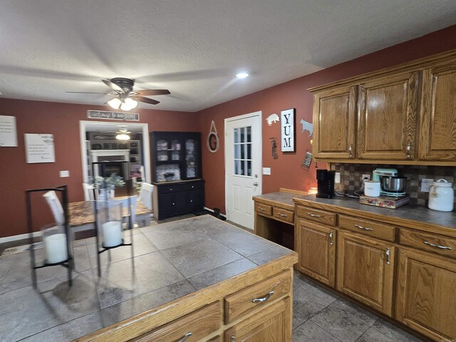 2373 W Rd, Mount Pleasant, AR 72561 - kitchen featuring ceiling fan, brown cabinets, tasteful backsplash, a textured ceiling, and recessed lighting