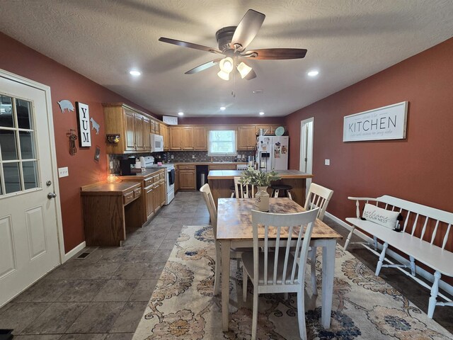 2373 W Rd, Mount Pleasant, AR 72561 - dining area with a ceiling fan, baseboards, a textured ceiling, and recessed lighting