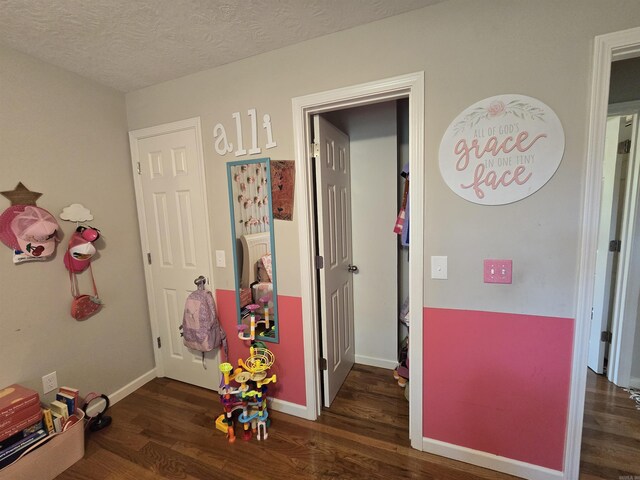 2373 W Rd, Mount Pleasant, AR 72561 - recreation room featuring wood finished floors, baseboards, and a textured ceiling