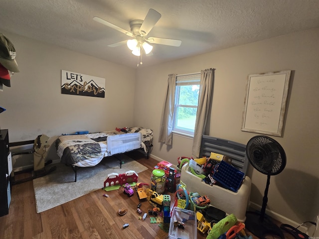 2373 W Rd, Mount Pleasant, AR 72561 - bedroom featuring wood finished floors, baseboards, ceiling fan, and a textured ceiling
