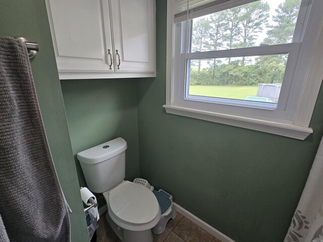 2373 W Rd, Mount Pleasant, AR 72561 - bathroom with toilet, baseboards, tile patterned floors, and curtained shower