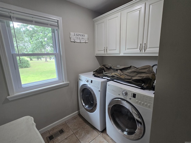 2373 W Rd, Mount Pleasant, AR 72561 - laundry room featuring washing machine and clothes dryer, cabinet space, baseboards, and light tile patterned flooring