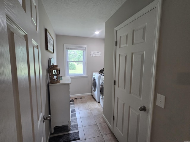 2373 W Rd, Mount Pleasant, AR 72561 - laundry area with independent washer and dryer, light tile patterned floors, baseboards, and a textured ceiling