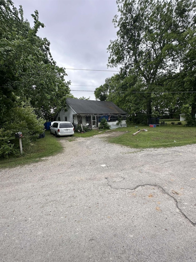 588 S Terminal, Piggott, AR 72454 - bungalow-style home with gravel driveway and a front yard