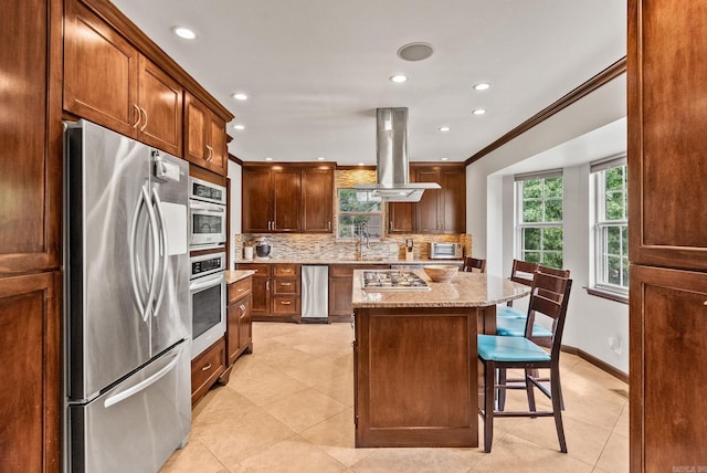 14 Cambay Ct, Little Rock, AR 72211 - kitchen with appliances with stainless steel finishes, island range hood, plenty of natural light, decorative backsplash, and recessed lighting