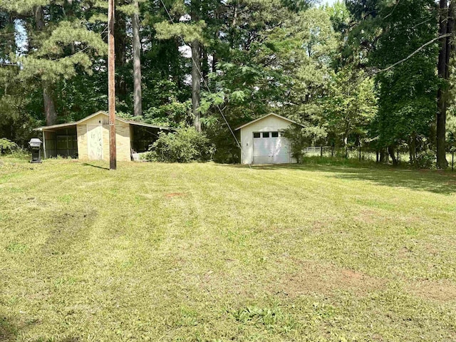 171 Sumter Dr, Malvern, AR 72104 - view of grassy yard featuring a detached garage and a shed