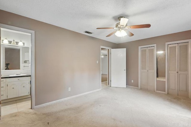 3 Kordsmeier Ct, Little Rock, AR 72205 - unfurnished bedroom with multiple closets, light carpet, a textured ceiling, baseboards, and ensuite bath