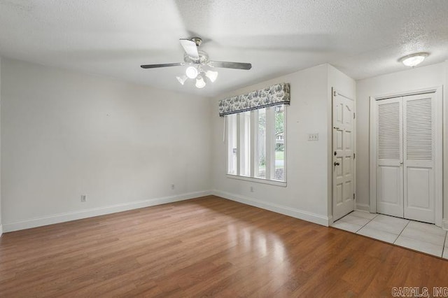 3 Kordsmeier Ct, Little Rock, AR 72205 - foyer entrance with light wood-type flooring, ceiling fan, baseboards, and a textured ceiling