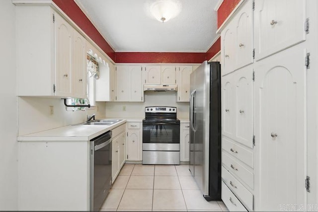 3 Kordsmeier Ct, Little Rock, AR 72205 - kitchen with stainless steel appliances, under cabinet range hood, light tile patterned flooring, light countertops, and white cabinetry