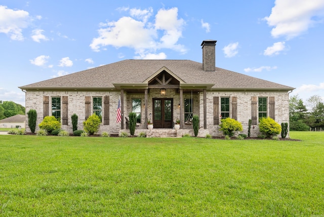 152 Clayboy Dr, Austin, AR 72007 - view of front facade featuring french doors, a front lawn, a chimney, a shingled roof, and brick siding