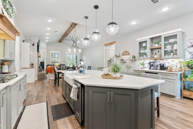 152 Clayboy Dr, Austin, AR 72007 - kitchen with a sink, decorative backsplash, a kitchen bar, light countertops, and recessed lighting