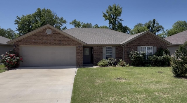 single story home with brick siding, an attached garage, driveway, a front yard, and a shingled roof