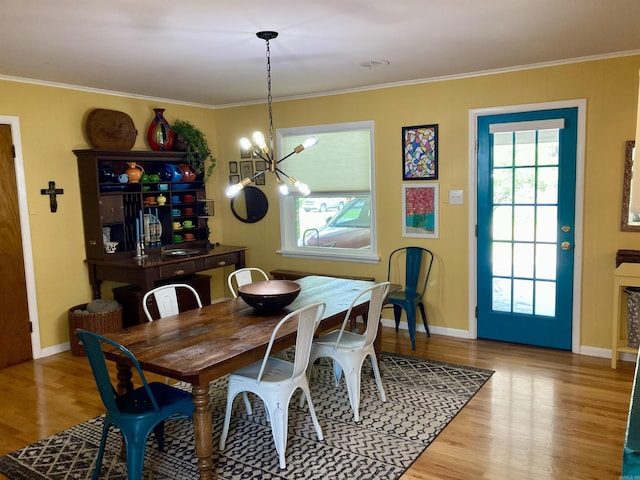 4613 Crestline Dr, North Little Rock, AR 72116 - dining room with a chandelier, wood finished floors, baseboards, and crown molding