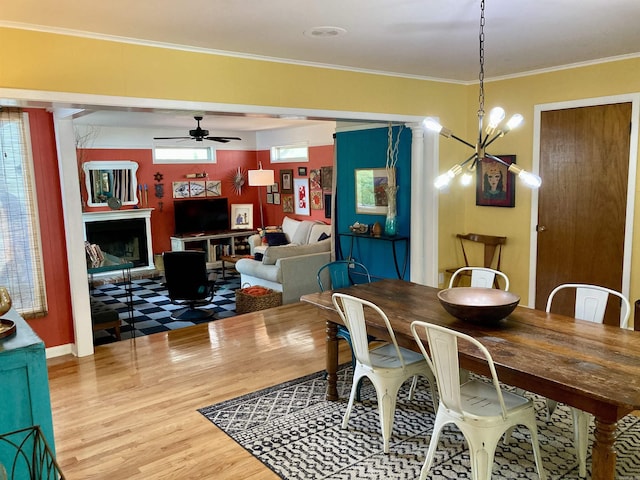 4613 Crestline Dr, North Little Rock, AR 72116 - dining area featuring wood finished floors, ceiling fan, a chandelier, and crown molding