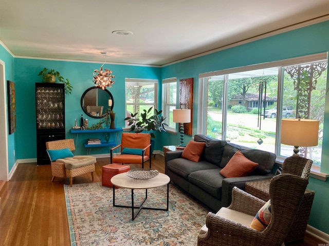 4613 Crestline Dr, North Little Rock, AR 72116 - living room with wood finished floors, baseboards, crown molding, and a chandelier