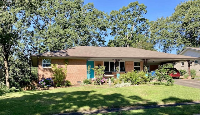 4613 Crestline Dr, North Little Rock, AR 72116 - view of front of house with brick siding, a front yard, a carport, and asphalt driveway