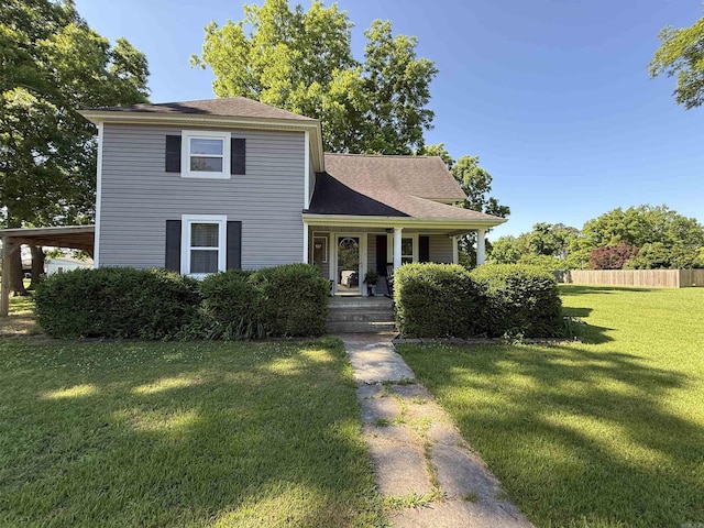 507 E Bruce St, Piggott, AR 72454 - view of front of house with a front yard, a porch, and a shingled roof