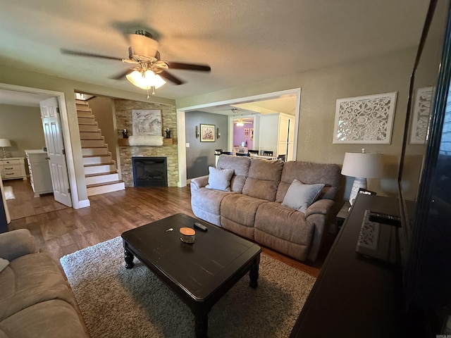 507 E Bruce St, Piggott, AR 72454 - living room with wood finished floors, ceiling fan, and a fireplace