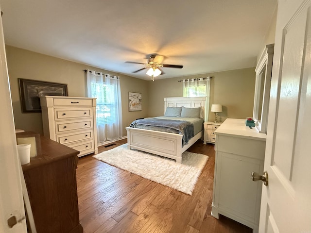 507 E Bruce St, Piggott, AR 72454 - bedroom featuring multiple windows, dark wood-type flooring, and ceiling fan