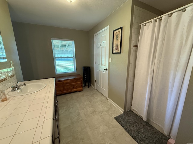 507 E Bruce St, Piggott, AR 72454 - bathroom featuring vanity, curtained shower, and baseboards