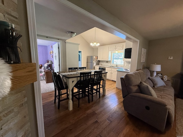 507 E Bruce St, Piggott, AR 72454 - dining space featuring dark wood-type flooring and a chandelier