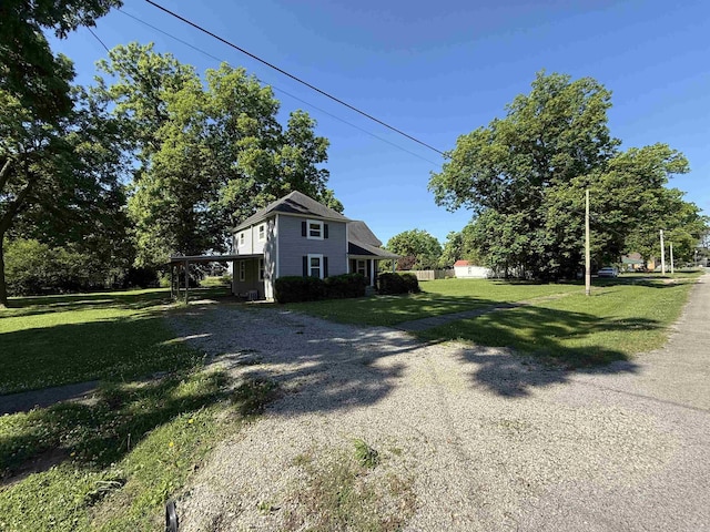 507 E Bruce St, Piggott, AR 72454 - view of side of property with gravel driveway and a yard