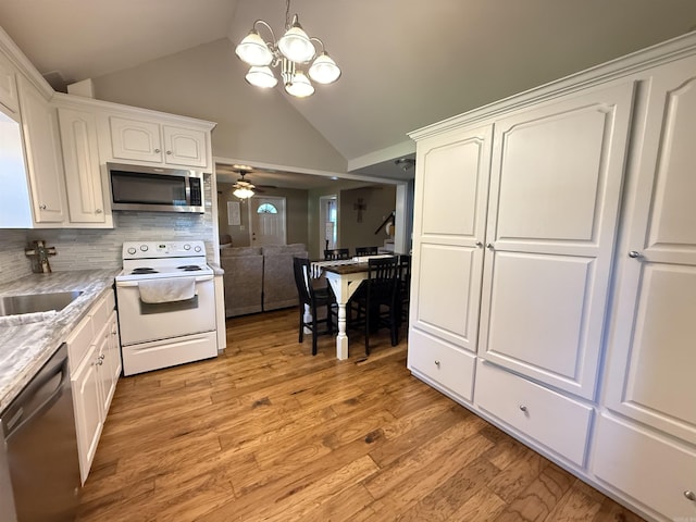 507 E Bruce St, Piggott, AR 72454 - kitchen featuring stainless steel appliances, white cabinetry, ceiling fan, backsplash, and light wood-style floors