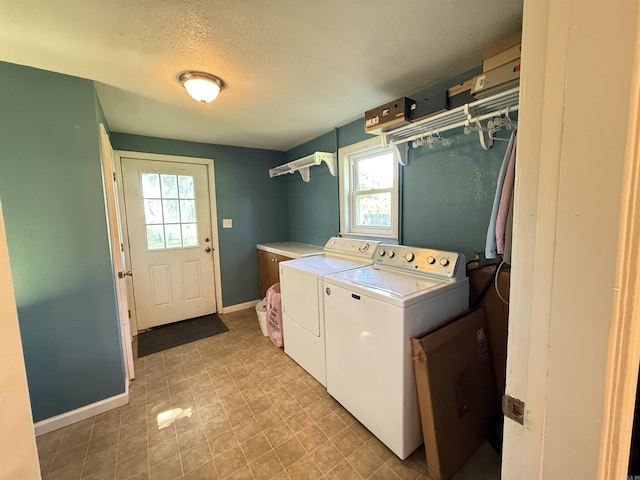 507 E Bruce St, Piggott, AR 72454 - washroom with plenty of natural light, washer and dryer, a textured ceiling, and baseboards