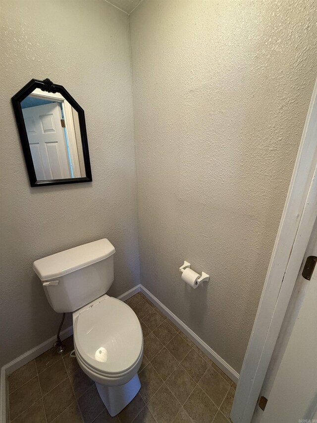 507 E Bruce St, Piggott, AR 72454 - bathroom with toilet, tile patterned flooring, and baseboards