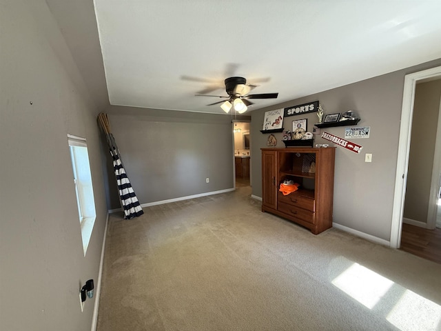 507 E Bruce St, Piggott, AR 72454 - unfurnished living room featuring a ceiling fan, light carpet, and baseboards