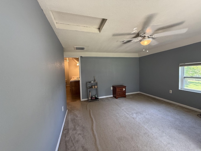 507 E Bruce St, Piggott, AR 72454 - carpeted spare room with attic access, a ceiling fan, and baseboards