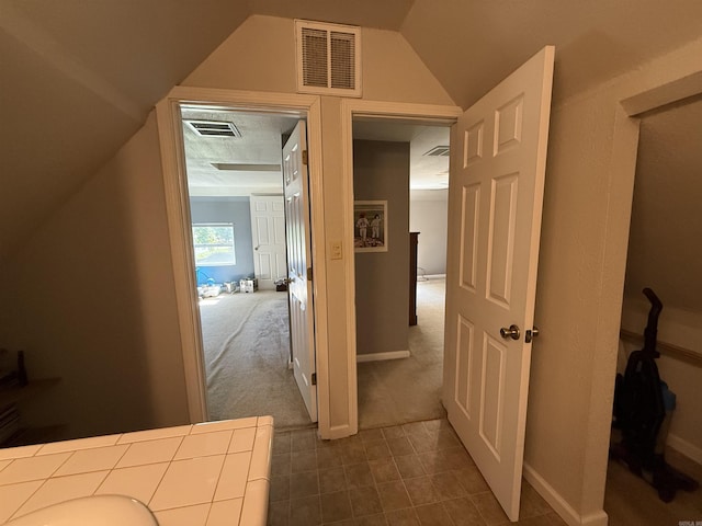 507 E Bruce St, Piggott, AR 72454 - hall with lofted ceiling, dark carpet, and baseboards