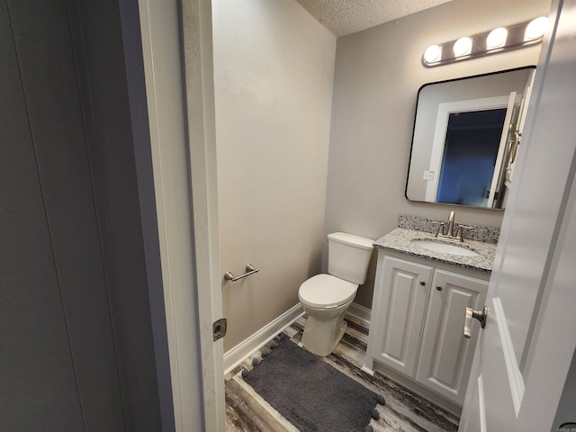 211 Burnt Rock Falls Rd, Fairfield Bay, AR 72088 - bathroom featuring toilet, wood finished floors, vanity, and a textured ceiling