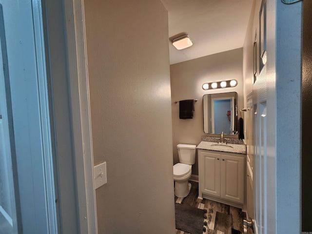 211 Burnt Rock Falls Rd, Fairfield Bay, AR 72088 - half bathroom with toilet, vanity, and wood finished floors
