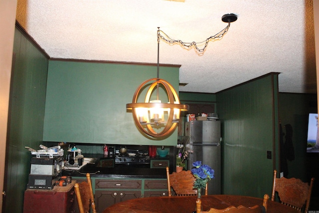 505 Woodland St, Malvern, AR 72104 - kitchen with freestanding refrigerator, ornamental molding, dark countertops, a chandelier, and a textured ceiling